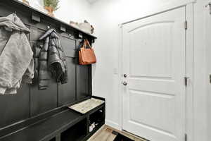 Mudroom featuring wood-type flooring