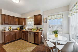 Kitchen featuring dishwasher, light wood-type flooring, and sink