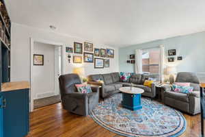 Living room with dark hardwood / wood-style floors