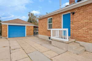 Exterior space with an outbuilding and a garage