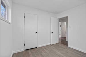 Unfurnished bedroom featuring light hardwood / wood-style floors