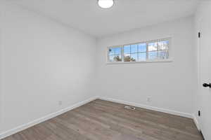 Spare room with hardwood / wood-style flooring