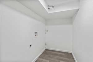 Laundry room featuring washer hookup, hookup for an electric dryer, and wood-type flooring