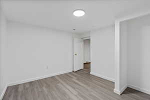 Unfurnished room with light hardwood / wood-style floors