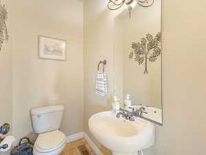 Bathroom featuring tile patterned flooring, toilet, and sink