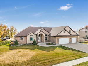 View of front of home featuring a front lawn and a garage