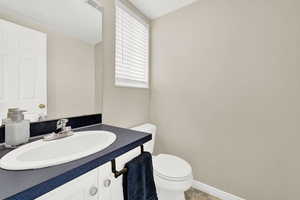 Bathroom with tile patterned flooring, vanity, and toilet