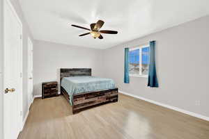 Bedroom featuring ceiling fan and light wood-type flooring