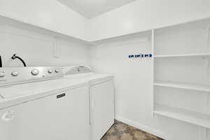 Washroom with washing machine and clothes dryer