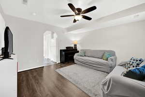 Living room featuring dark hardwood / wood-style floors and ceiling fan