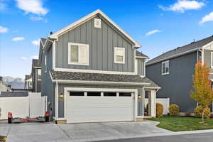 View of front of house with a mountain view and a garage