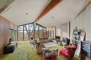 Sunroom with vaulted ceiling with beams