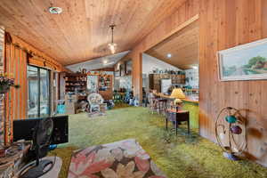 Interior space with wood walls, wooden ceiling, and lofted ceiling