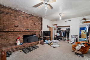 Carpeted living room featuring a textured ceiling