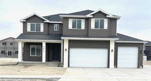 View of front of property featuring a porch and a garage