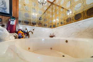 Bathroom with a bath and tile walls