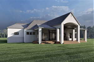 Rear view of house featuring a deck and a lawn