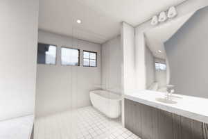 Bathroom featuring a tub to relax in, tile patterned flooring, and vanity