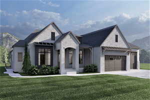 French provincial home with a mountain view, a front lawn, and a garage