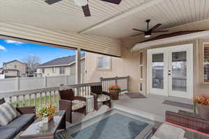 View of patio with outdoor lounge area, ceiling fan, and french doors