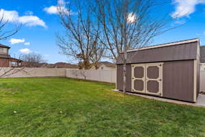 View of yard with a storage unit