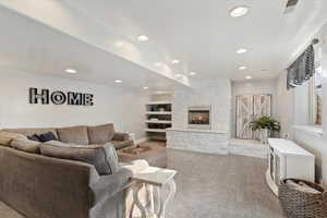 Carpeted living room featuring a fireplace