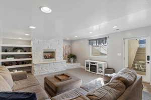 Carpeted living room with a fireplace