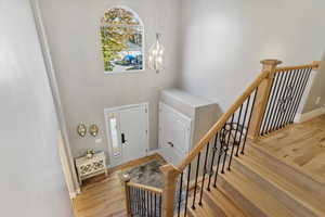 Foyer entrance featuring light wood-type flooring and a notable chandelier