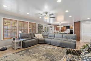 Living room with light wood-type flooring and ceiling fan