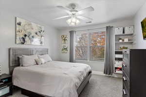 Bedroom featuring ceiling fan and light carpet