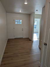 Entrance foyer featuring a textured ceiling and dark hardwood / wood-style flooring