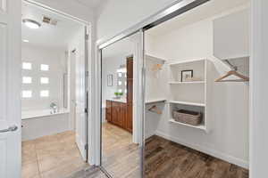 Bathroom featuring vanity, wood-type flooring, and independent shower and bath