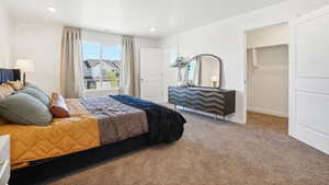 Bedroom featuring carpet flooring, a walk in closet, and a closet