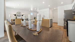 Dining room with light hardwood / wood-style floors and sink