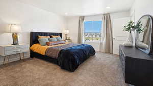 Bedroom featuring light carpet