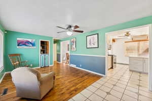 Living room featuring ceiling fan and light hardwood / wood-style floors