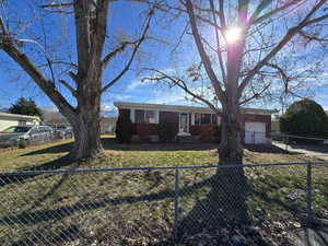 View of front of house featuring brick siding and fence private yard