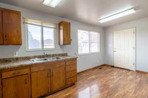 Kitchen with sink and light hardwood / wood-style flooring