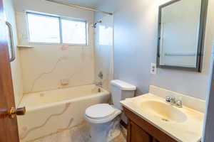 Full bathroom featuring vanity, toilet, and tub / shower combination