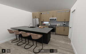 Kitchen with decorative backsplash, appliances with stainless steel finishes, light wood-type flooring, a breakfast bar, and sink