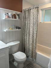 Full bathroom featuring tile patterned flooring, shower / bath combination with curtain, vanity, and toilet