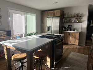 Kitchen featuring tasteful backsplash, dark wood-type flooring, and appliances with stainless steel finishes