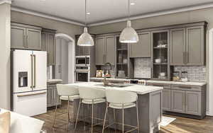 Kitchen featuring sink, hanging light fixtures, stainless steel appliances, dark hardwood / wood-style flooring, and decorative backsplash