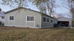 View of property exterior featuring a garage and an outdoor structure