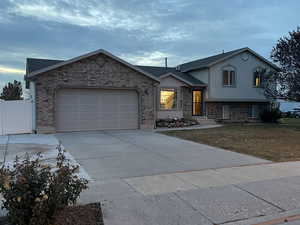 Split level home featuring a garage and a front yard