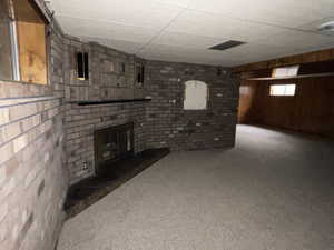 Basement with a fireplace and a paneled ceiling