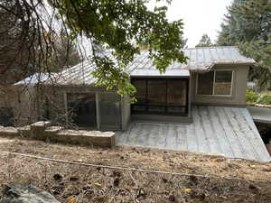 Rear view of house with a sunroom