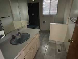 Bathroom featuring tile patterned floors and vanity