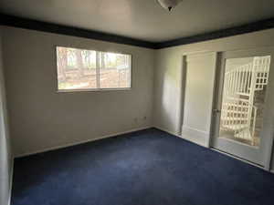 Unfurnished bedroom featuring dark colored carpet