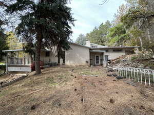 Back of house featuring a wooden deck